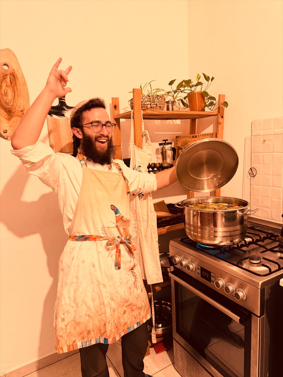 Shimi in the early days of the business, lifting the lid from a large pot of broth.
